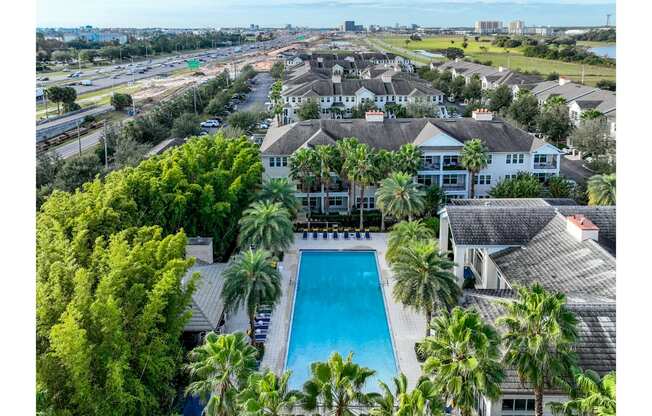 a mansion with a pool and palm trees