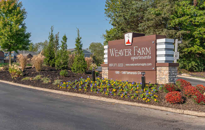 the welcome sign at weaver farm apartments