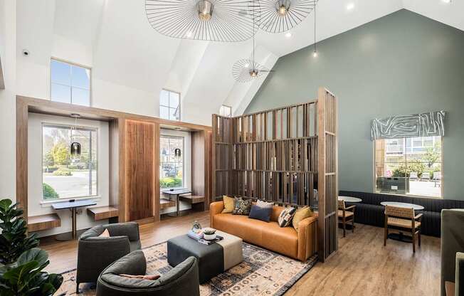 A living room with a large couch and a wooden partition.