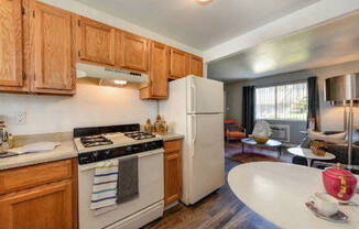  Kitchen with View of Living Room,  Hardwood Inspired Floors, Oven and Wood Cabinets