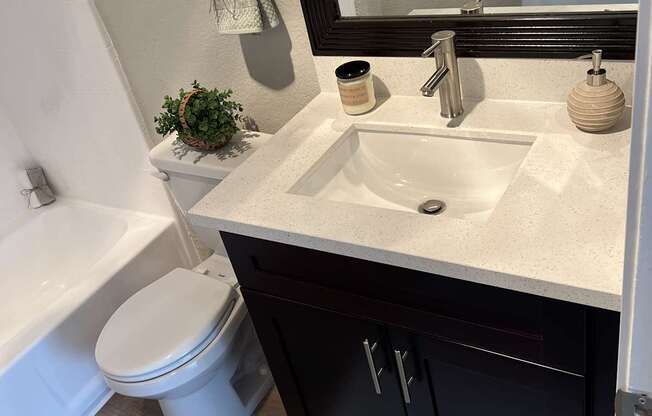 a bathroom with a toilet and a sink and a mirror