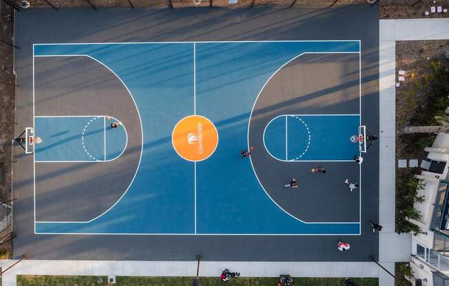 A basketball court with a blue surface and white lines.