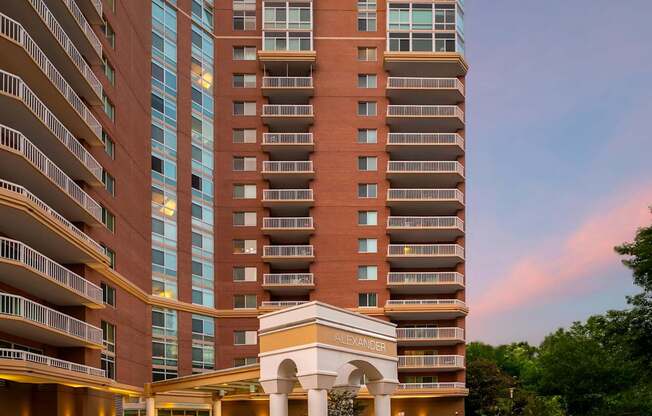 A large hotel with a white entrance and balconies.