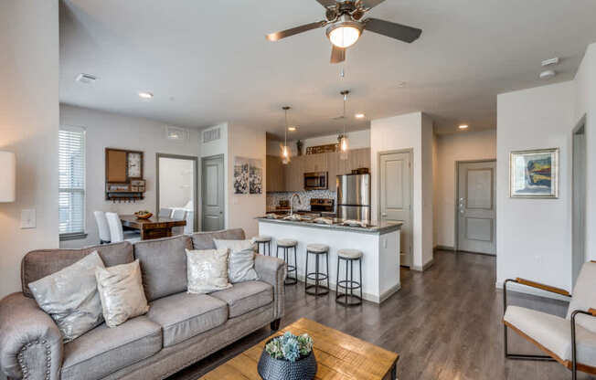 A modern living room with a grey couch and a wooden coffee table.