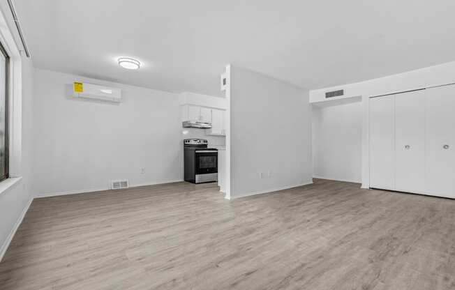 a living room with white walls and hardwood floors