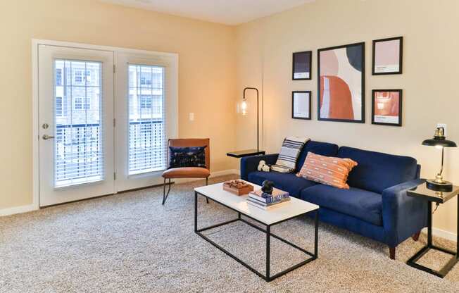 a living room with a blue couch and a coffee table