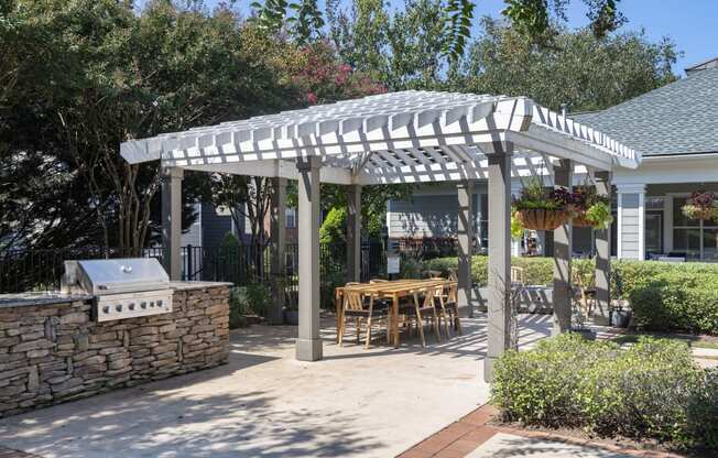 a pergola with a table and chairs under it