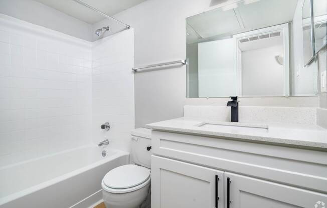 a bathroom with a sink toilet and a mirror
