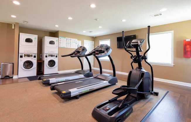Fitness Center at Archers Pointe with treadmills, elliptical machine and washer and dryer sets.