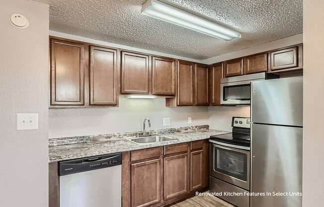 A kitchen with brown cabinets and stainless steel appliances.
