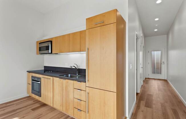 A kitchen with wooden cabinets and a microwave above the stove.