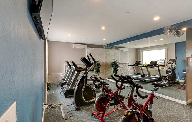 Fitness center with treadmills, ellipticals and bikes  at OceanAire Apartment Homes, Pacifica, CA