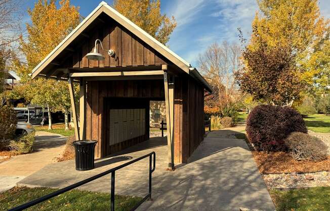 A wooden covered walkway leads to a building.