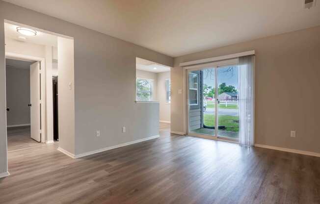 a living room with wood floors and a sliding glass door