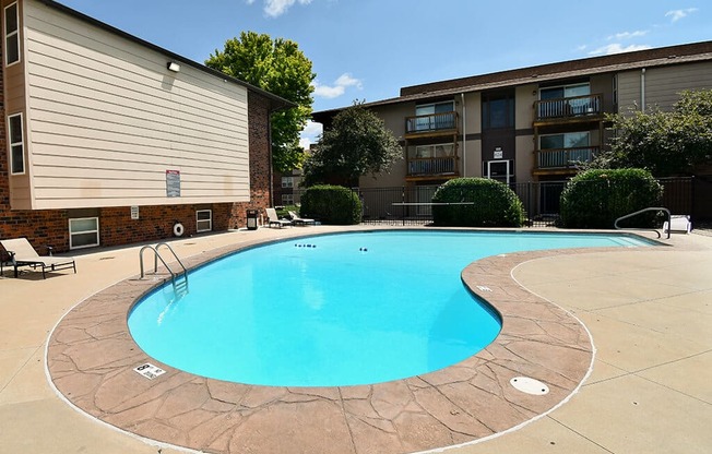 a swimming pool in front of an apartment building