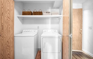 a small laundry room with two washes and a dryer at Eagles Landing Apartments, Everett, 98204