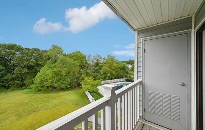 a view of the yard from the balcony of an apartment with a pool at ReNew Odenton