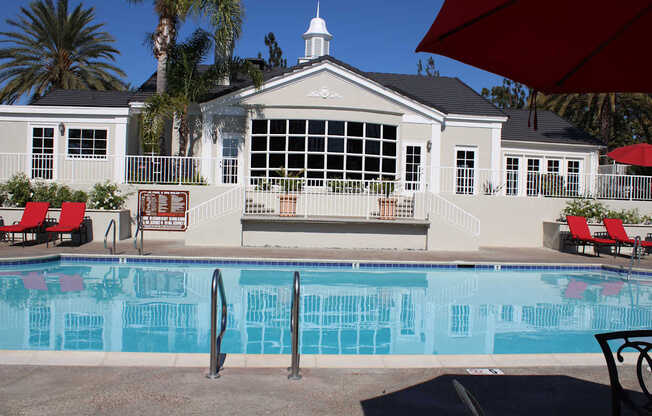 A pool with a building behind it.