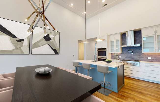 a kitchen and dining room with a black dining table and a blue kitchen