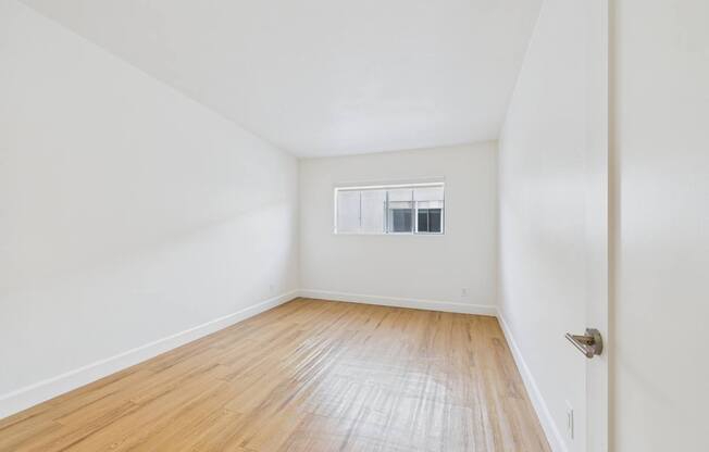A room with wooden floors and white walls.