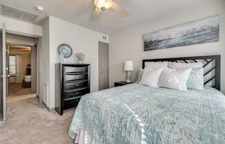 a bedroom with a bed and a ceiling fan