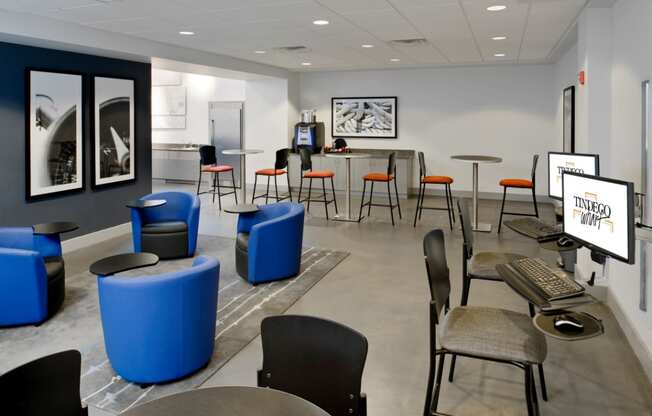 a room with tables and chairs and a desk with a computer at Tindeco Wharf, Maryland, 21224