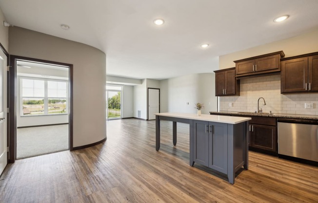 an open kitchen and living room with a large island in the middle