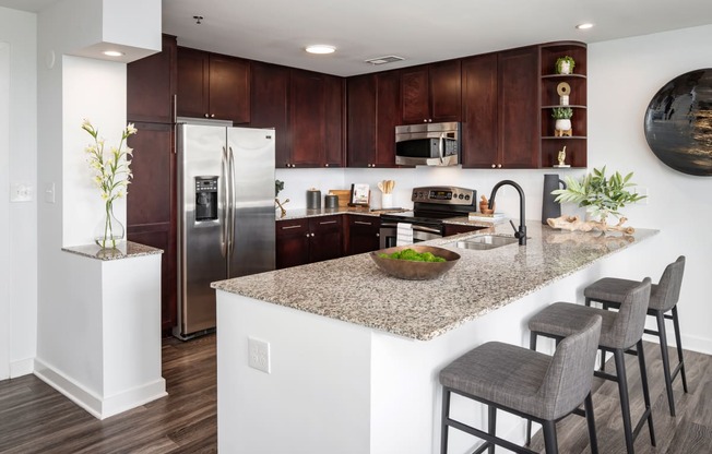 a kitchen with a large island with a granite counter top