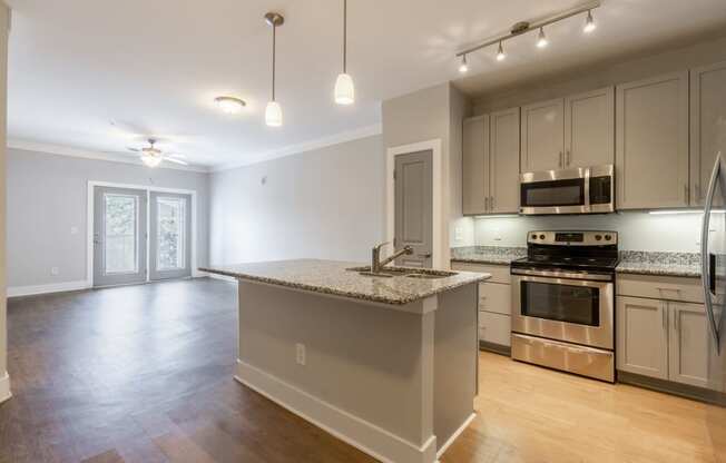 kitchen with stainless appliances, hardwood-style flooring, and kitchen island