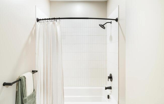 Subway tile surrounds and matte black fixtures give the bathroom a fresh, modern feel.