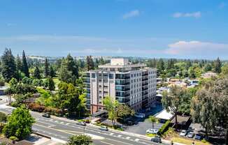 A large building with a parking lot in front of it.