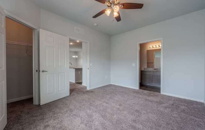 a bedroom with a ceiling fan and a closet