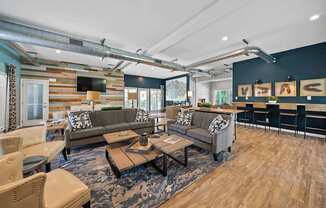 A modern living room with a wooden floor and a large sectional sofa.
