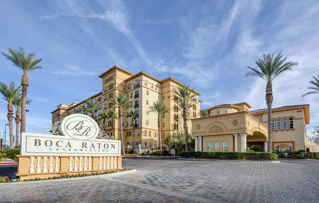 The Boca Raton building is a large, tan, multi-story hotel with palm trees in front.