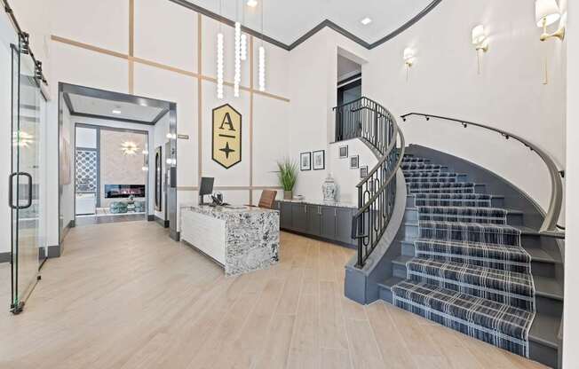 A modern interior with a staircase and a reception desk.