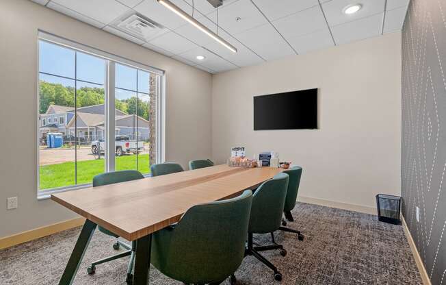 a conference room with a large window and a flat screen tv at The Lodge at Overland, Minnesota