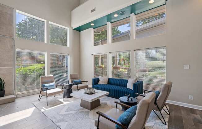 a seating area with a row of chairs and a wall of windows