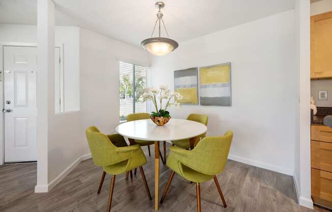 a dining room with a table and four chairs