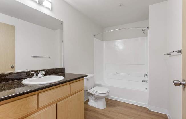 A bathroom with a sink, toilet, and bathtub.