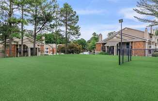 community yard with fence and apartment buildings at The Davis Apartments, Huntsville, AL  