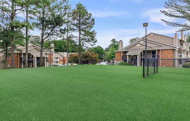 community yard with fence and apartment buildings at The Davis Apartments, Huntsville, AL  