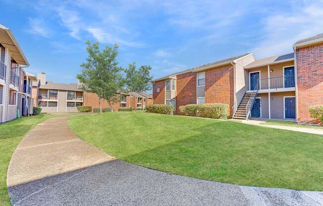 A sunny day at a residential complex with a clear blue sky.