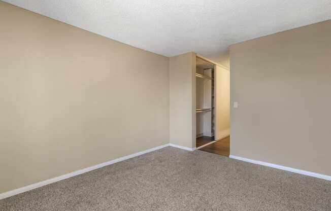a bedroom with beige walls and a carpeted floor
