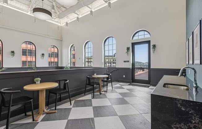 A black and white checkered floor in a room with a table and chairs.