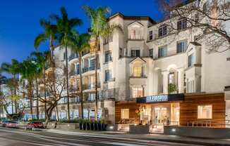 Miracle Mile Los Angeles Apartments - Exterior View of The Preston Apartments Building Surrounded By Lush Landscaping