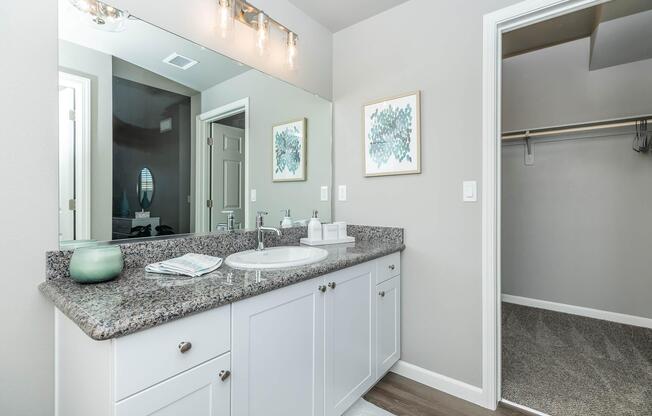 a kitchen with a sink and a mirror