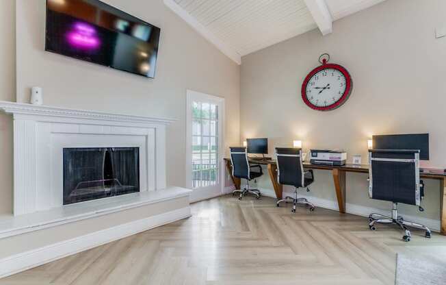 a home office with a fireplace and a clock on the wall