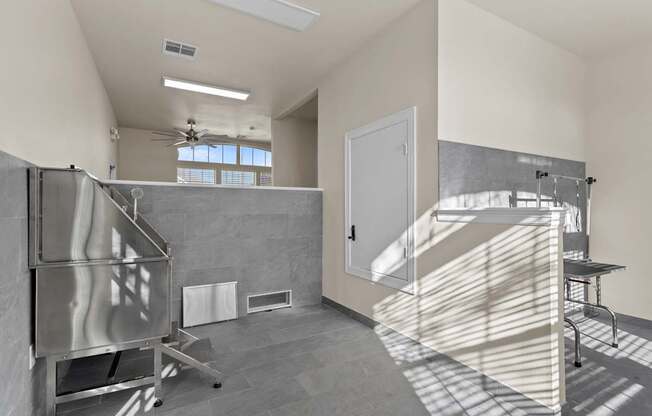 A kitchen area with a stainless steel refrigerator and a countertop with a sink.
