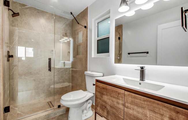 a bathroom with a toilet sink and shower