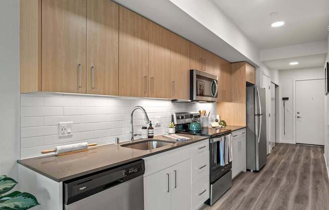 A modern kitchen with wooden cabinets and stainless steel appliances.